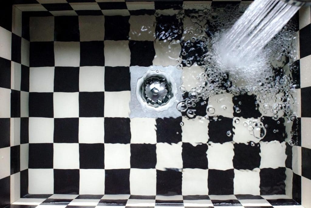 Tiled kitchen sink with flowing water